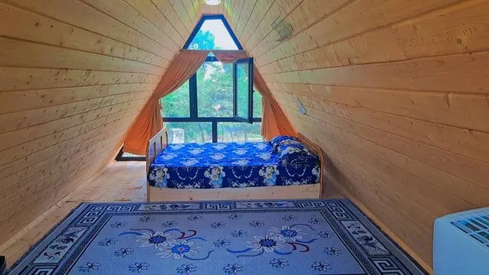 کلبه یک خوابه چاوان - نمایی از اتاق خواب که رو به درخت و رودخانه میباشد